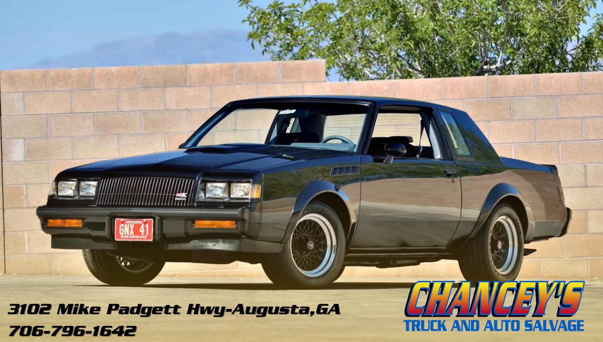 80s muscle car black sits in a brick driveway in the sun